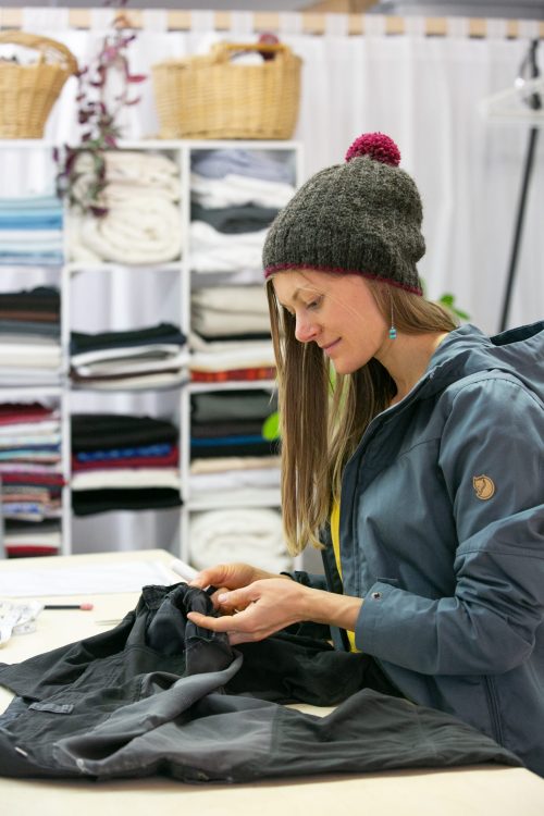 ELAYNA YUSSEN/Daily Courier
Inka Linn, a seamstress, designer, tailor, instructor, and artist repairs a pair of pants on Thursday at her new shop on Williams Highway in Grants Pass. Linn draws much of her inspiration from her Norwegian culture with a focus on quality, sustainability and tradition.